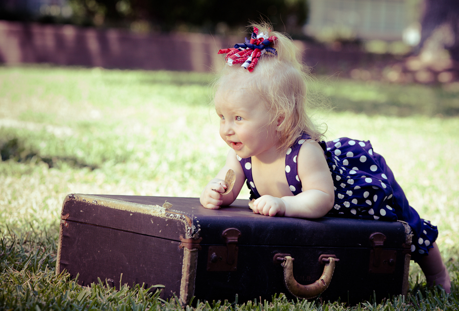 Adorable baby sitting in a vintage suitcase — portrait session